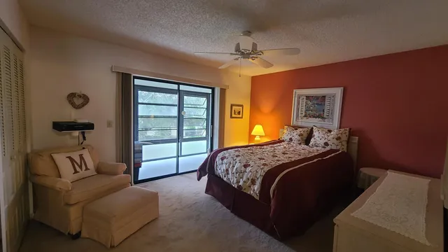 a bedroom with a bed couch and window
