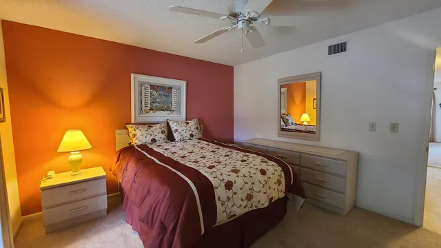 a bedroom with a bed and a lamp