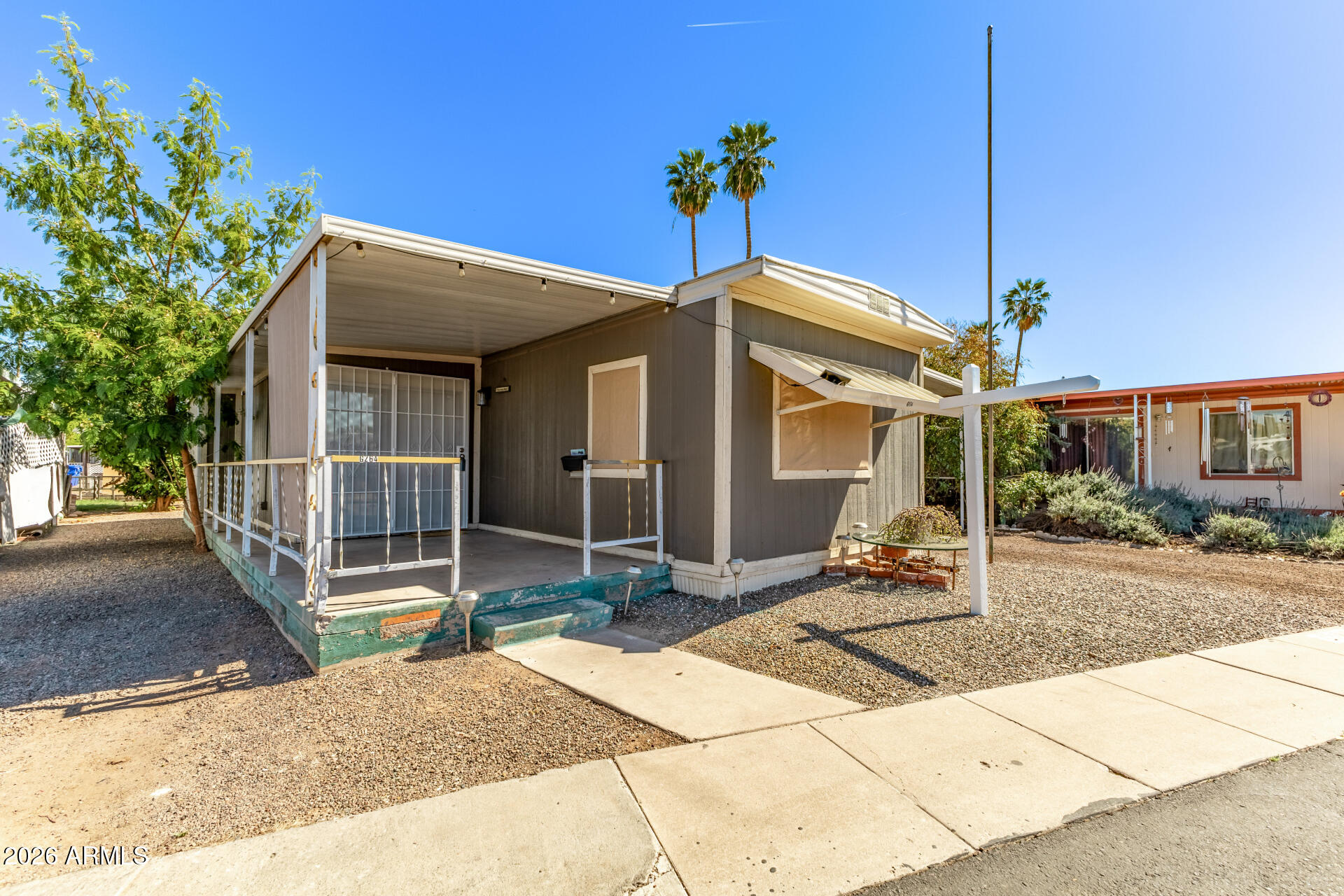 5201 West Camelback Road, Unit G264 Phoenix, AZ 85031 - Photo 14 of 16 a front view of a house with a porch