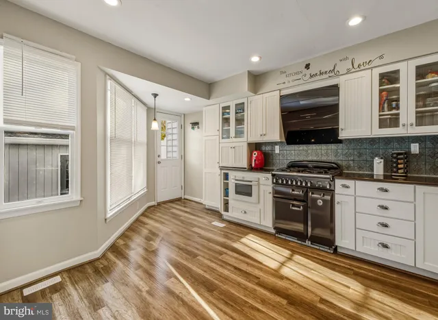 a kitchen with stainless steel appliances granite countertop a stove and a sink