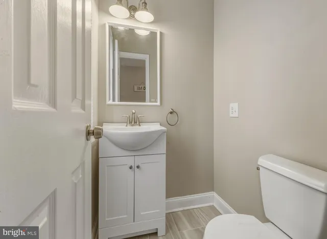 a bathroom with a sink toilet and vanity