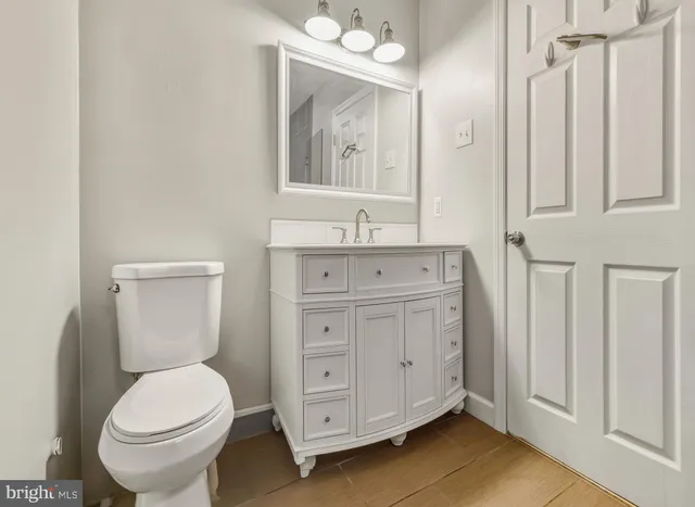a bathroom with a toilet a sink and mirror
