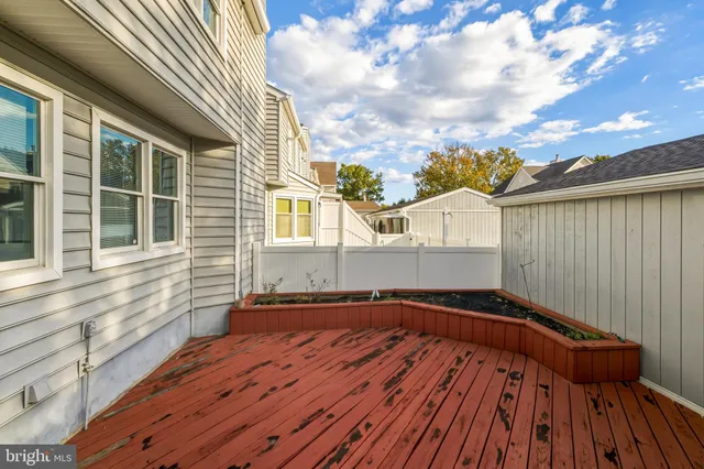 a view of balcony with wooden floor and fence