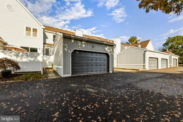a view of a grey house with a yard