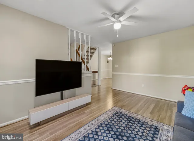 a living room with a flat screen tv and a rug
