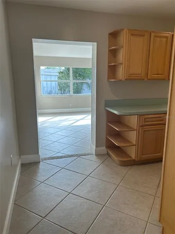 a view of a refrigerator in kitchen and furniture in a kitchen