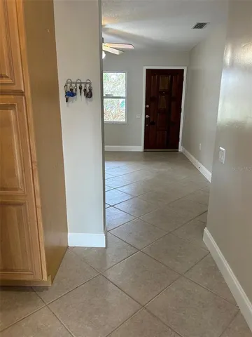 a bathroom with a granite countertop bathtub shower sink vanity and toilet