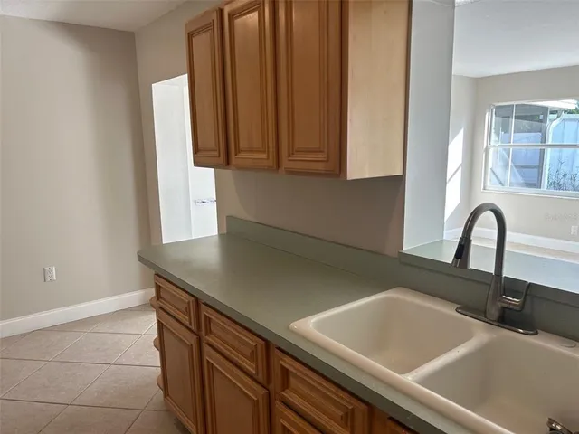 a bathroom with a granite countertop sink and a toilet