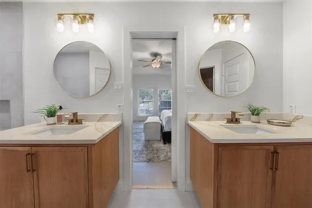 a bathroom with a double vanity sink and a mirror
