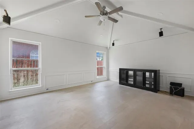 a view of an empty room with a window and fireplace