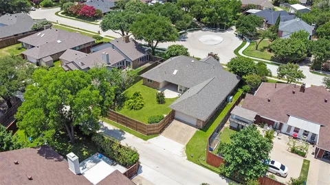 an aerial view of residential houses with outdoor space and street view