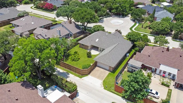 an aerial view of residential houses with outdoor space and street view