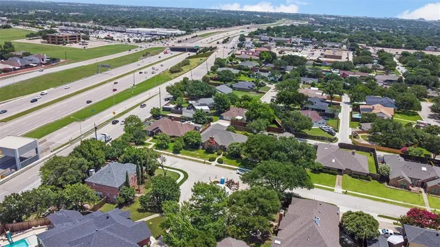 an aerial view of a city with streets and houses