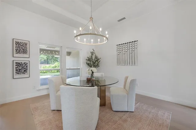 a dining room with chandelier and window