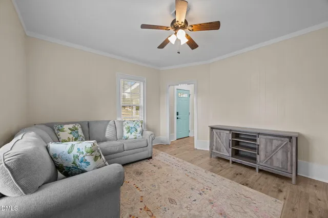 a kitchen with a dining table chairs and refrigerator