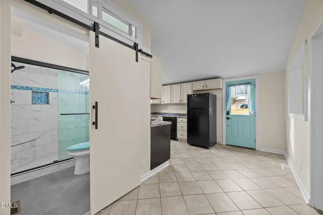 a kitchen with granite countertop white cabinets stainless steel appliances and a sink