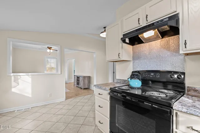 a room with a bed dresser and a window