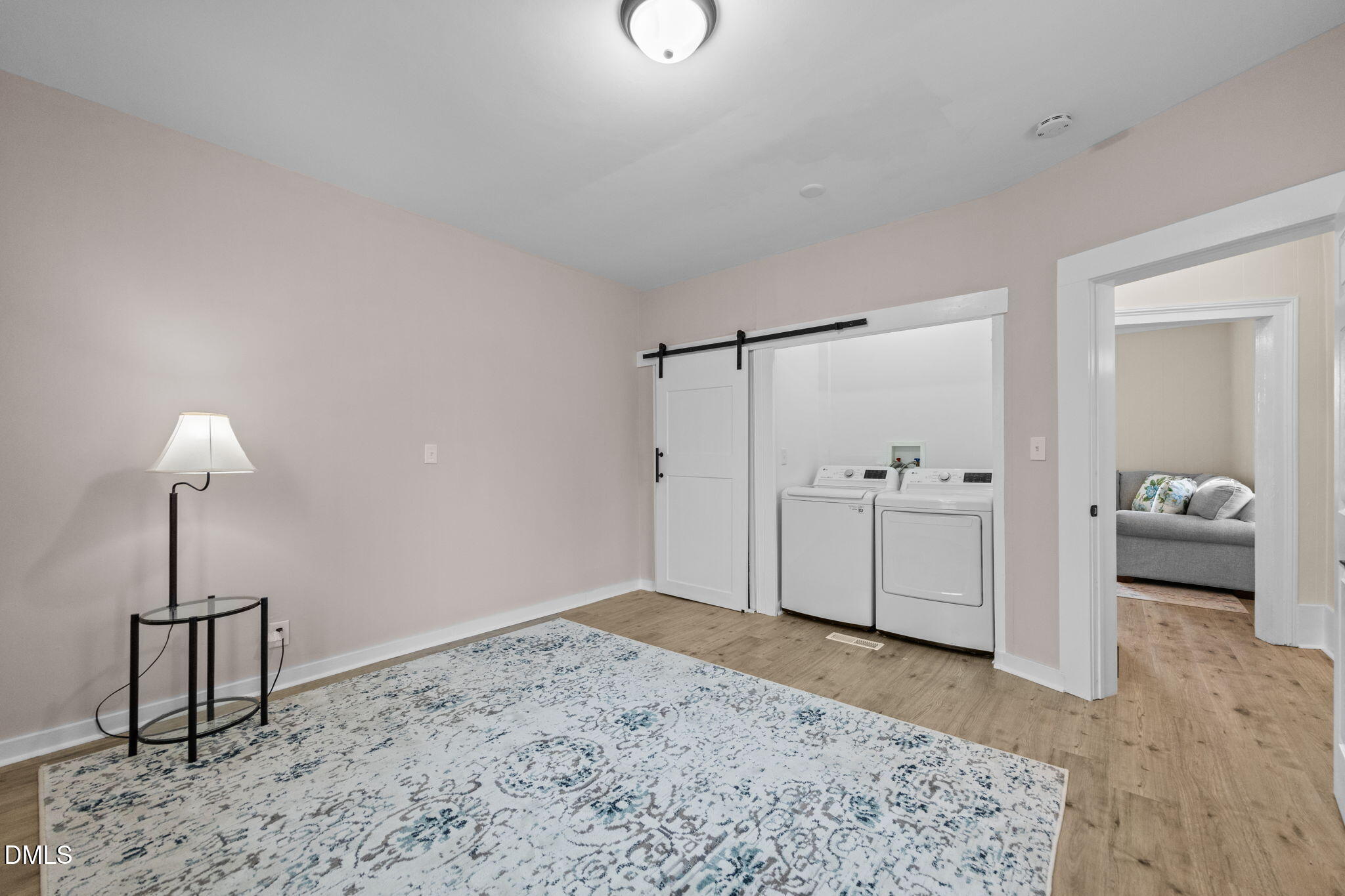 4325 Auburn Knightdale Road Raleigh, NC 27610 - Photo 30 of 34 a view of a bedroom with a bed and wooden floor