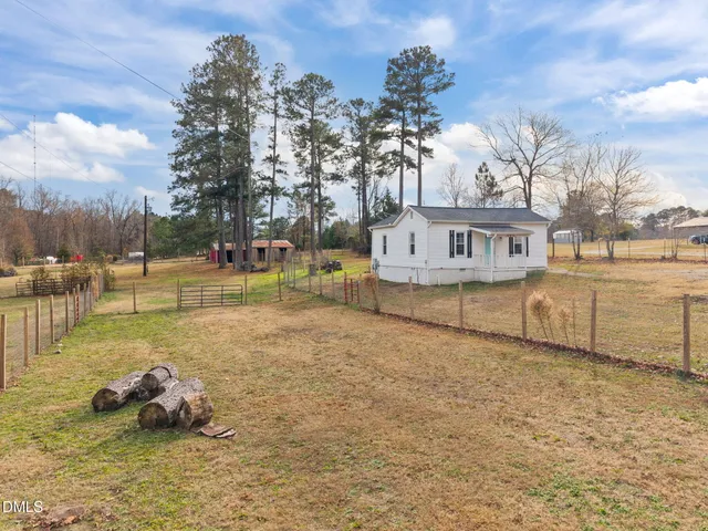 a swimming pool with outdoor seating and yard