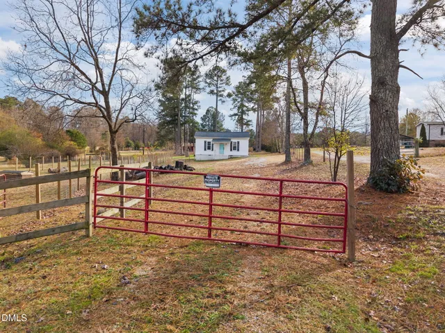a view of a bench sitting in middle of a yard
