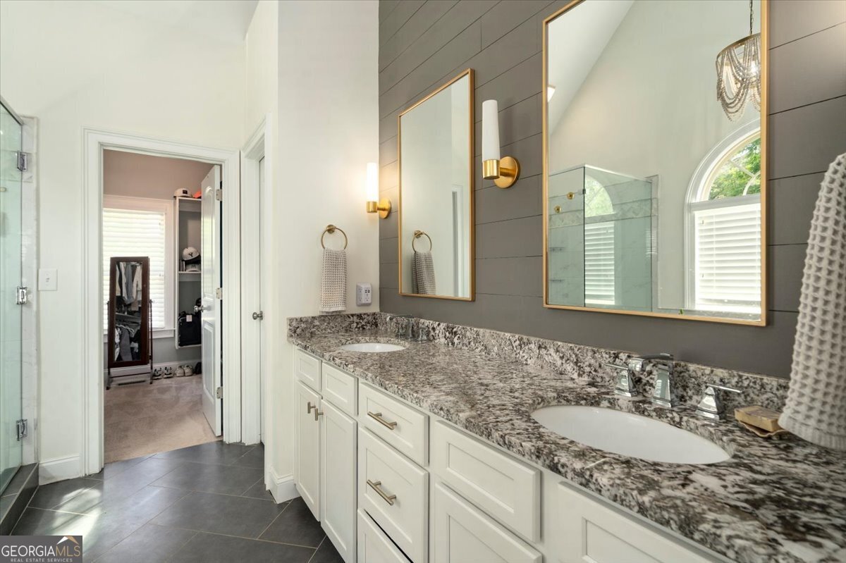 3093 Surry Ridge Drive Watkinsville, GA 30677 - Photo 13 of 41 a spacious bathroom with a granite countertop sink and a mirror