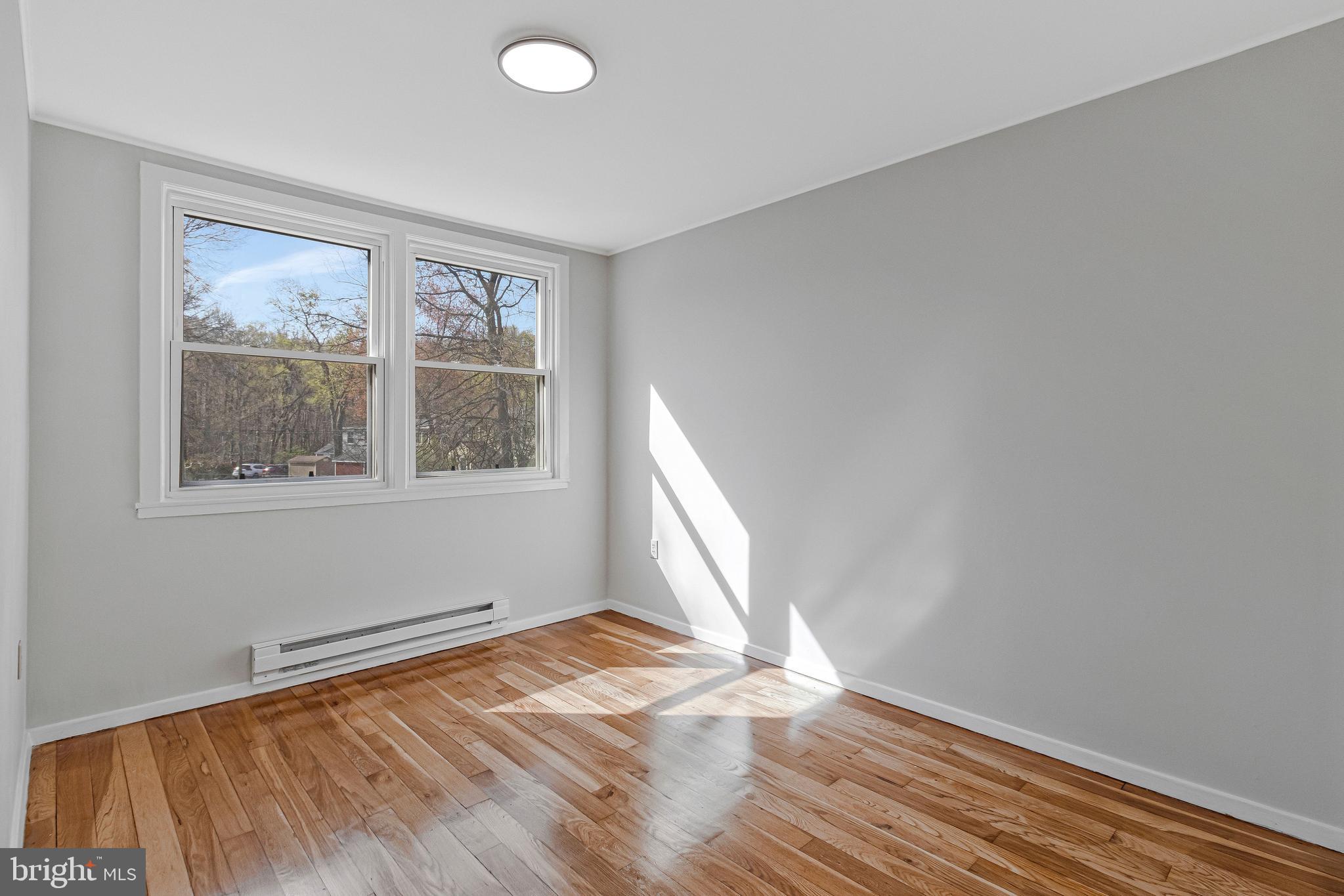 36 Ridge Road Greenbelt, MD 20770 - Photo 25 of 39 a view of empty room with wooden floor and fan