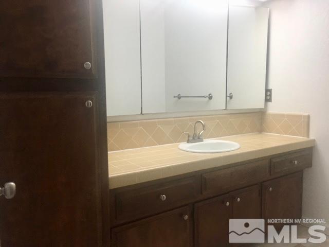 1937 South Villa Way Reno, NV 89509 - Photo 14 of 21 a bathroom with a sink and a mirror