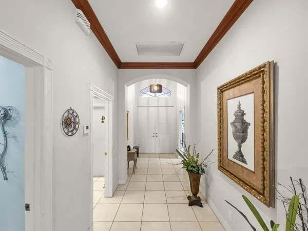 a view of a hallway to a livingroom with furniture