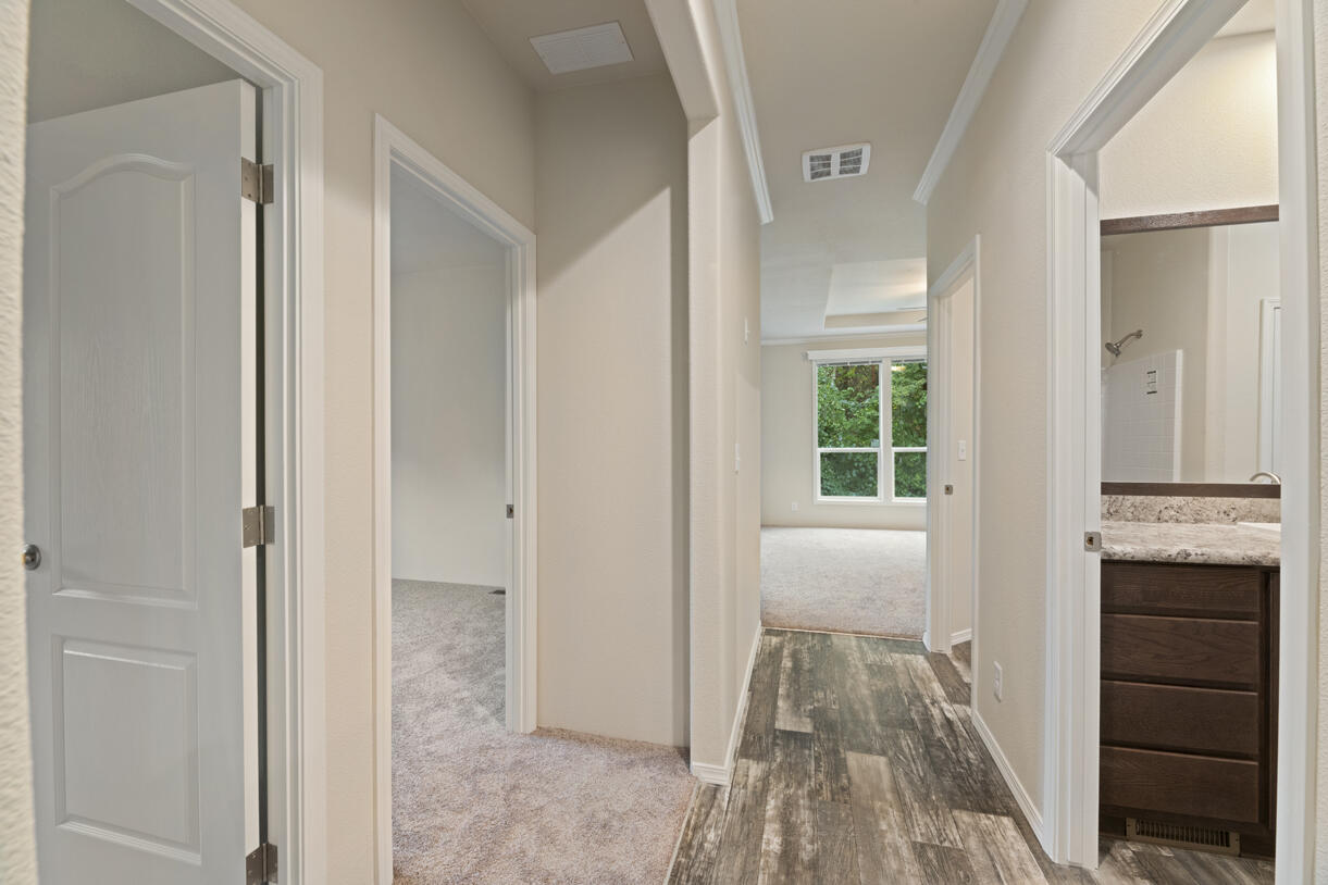 5572 Jumpoff Joe Creek Road Grants Pass, OR 97526 - Photo 16 of 38 a view of a hallway with bathroom and wooden floor