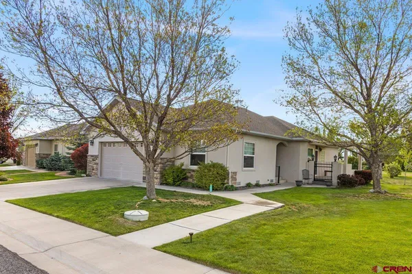 a front view of house with yard and green space