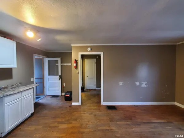 a view of a kitchen with a sink and cabinets