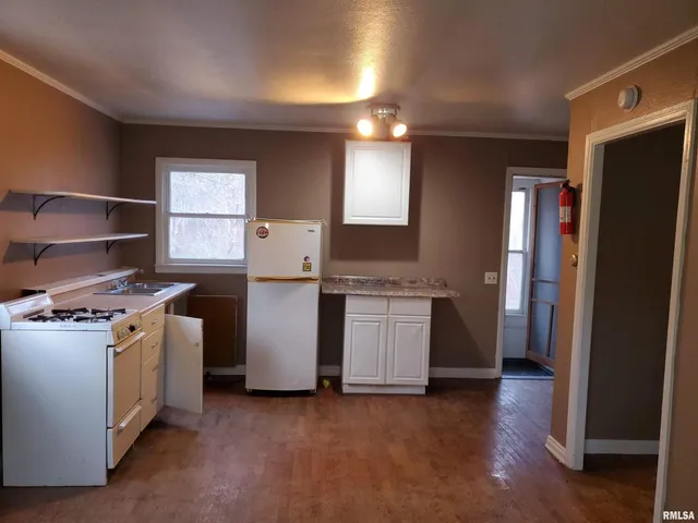 a kitchen with a stove and a refrigerator