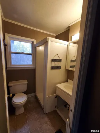 a bathroom with a toilet a sink a tub and mirror