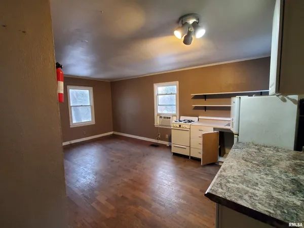 a kitchen with sink cabinets and wooden floor