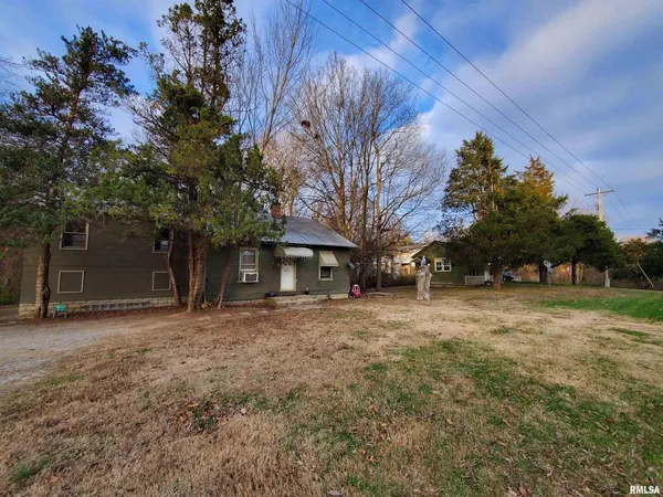 a house that has a tree in front of it