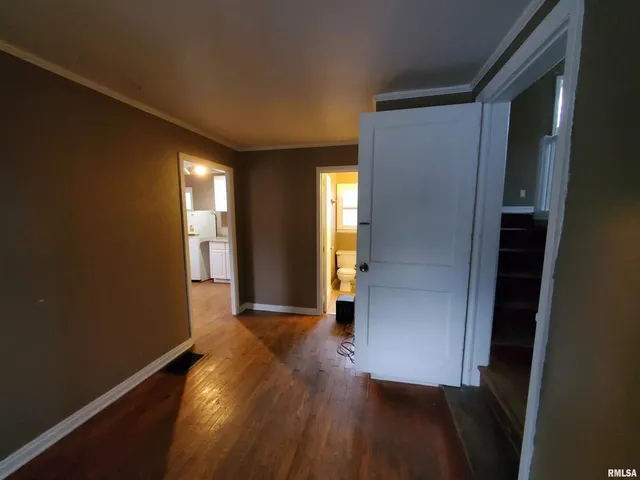 a view of hallway with wooden floor