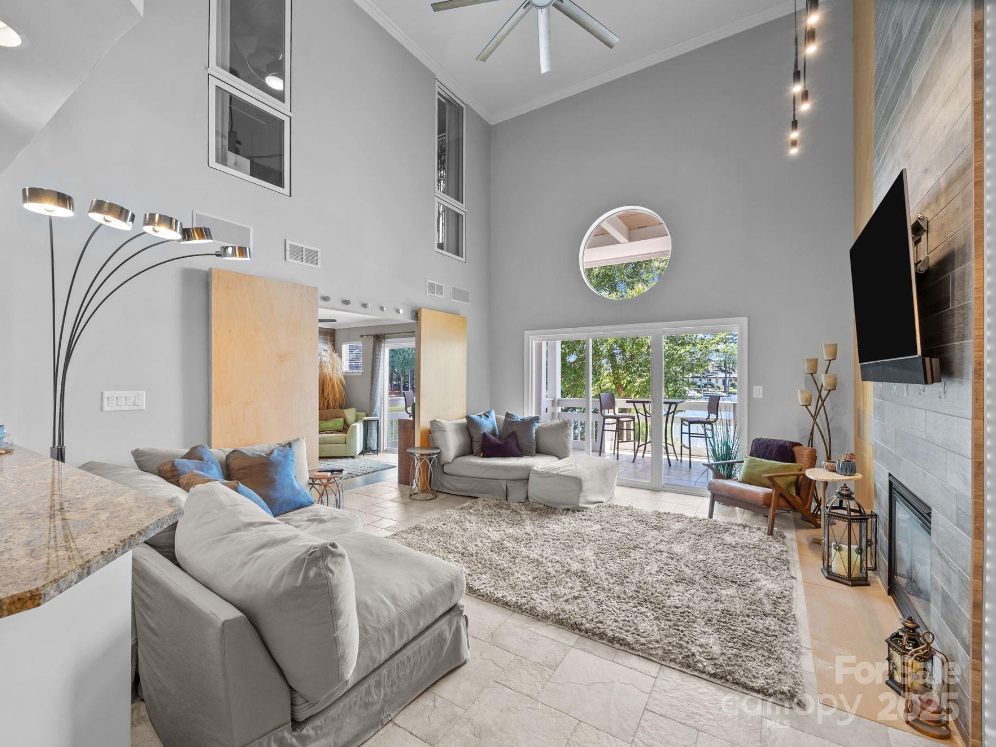 17925 Kings Point Drive, Unit F Cornelius, NC 28031 - Photo 15 of 35 a living room with furniture a fireplace and a flat screen tv