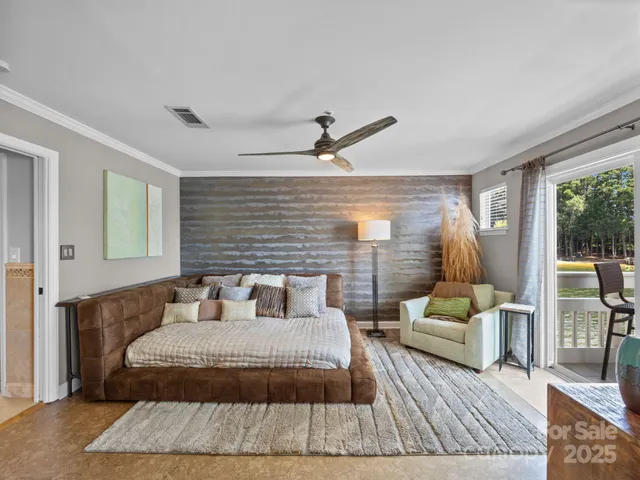 a bedroom with a large bed a rug and a large window