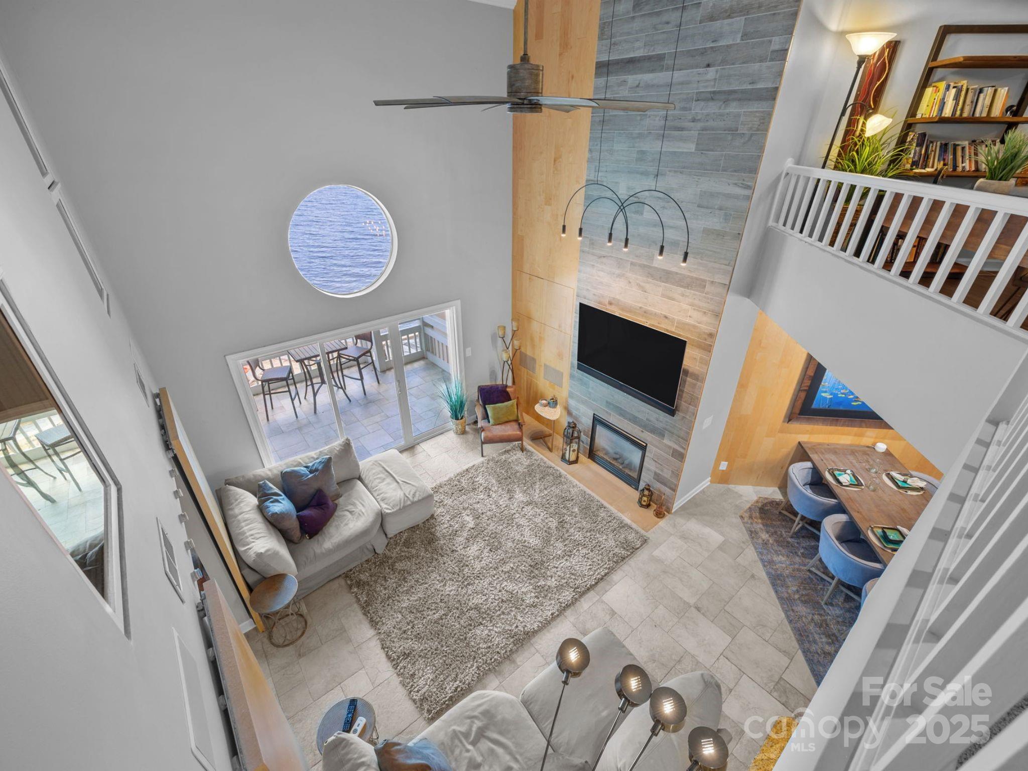 17925 Kings Point Drive, Unit F Cornelius, NC 28031 - Photo 22 of 35 a living room with furniture and a flat screen tv