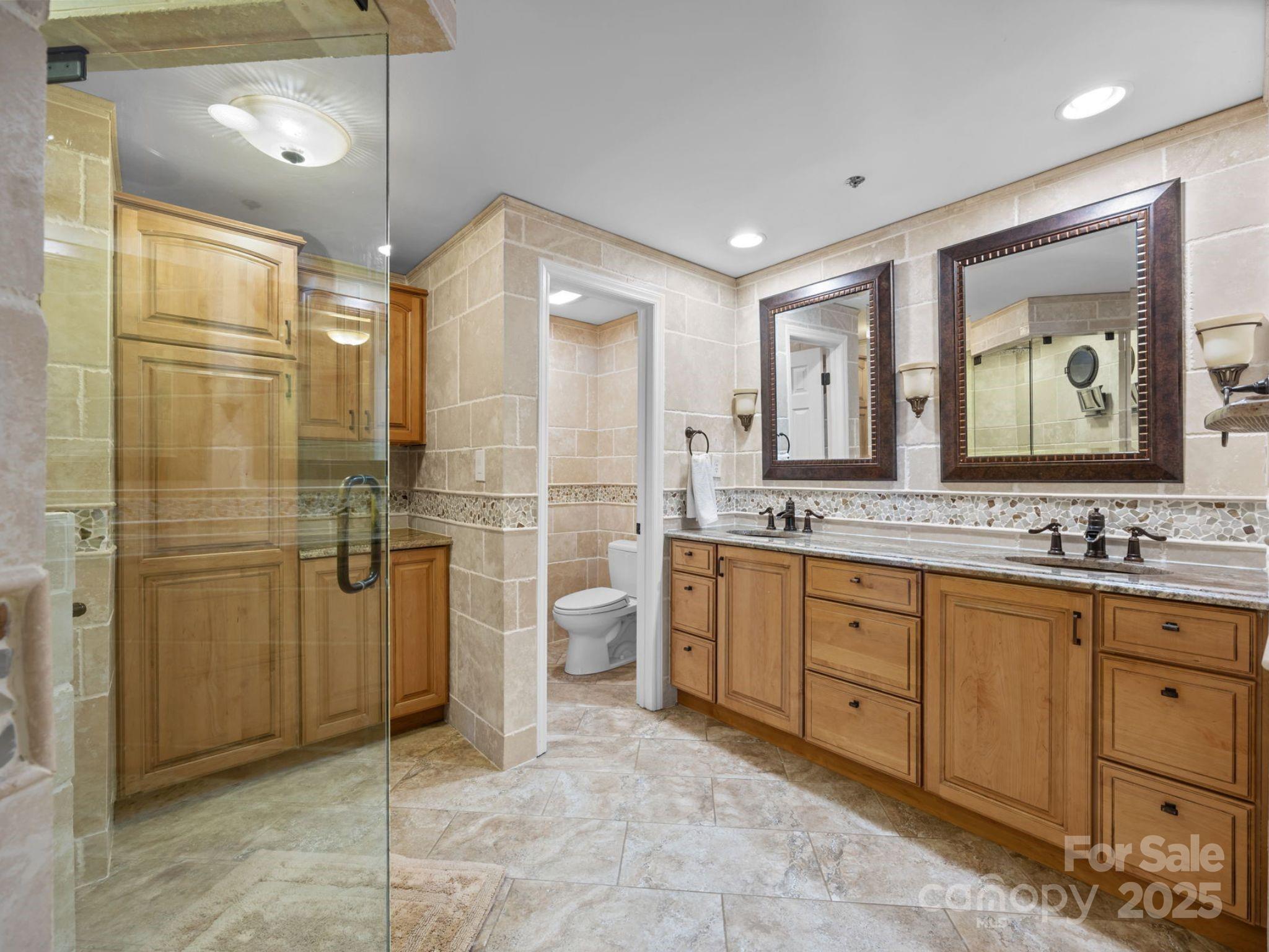 17925 Kings Point Drive, Unit F Cornelius, NC 28031 - Photo 24 of 35 a bathroom with a granite countertop sink mirror and shower