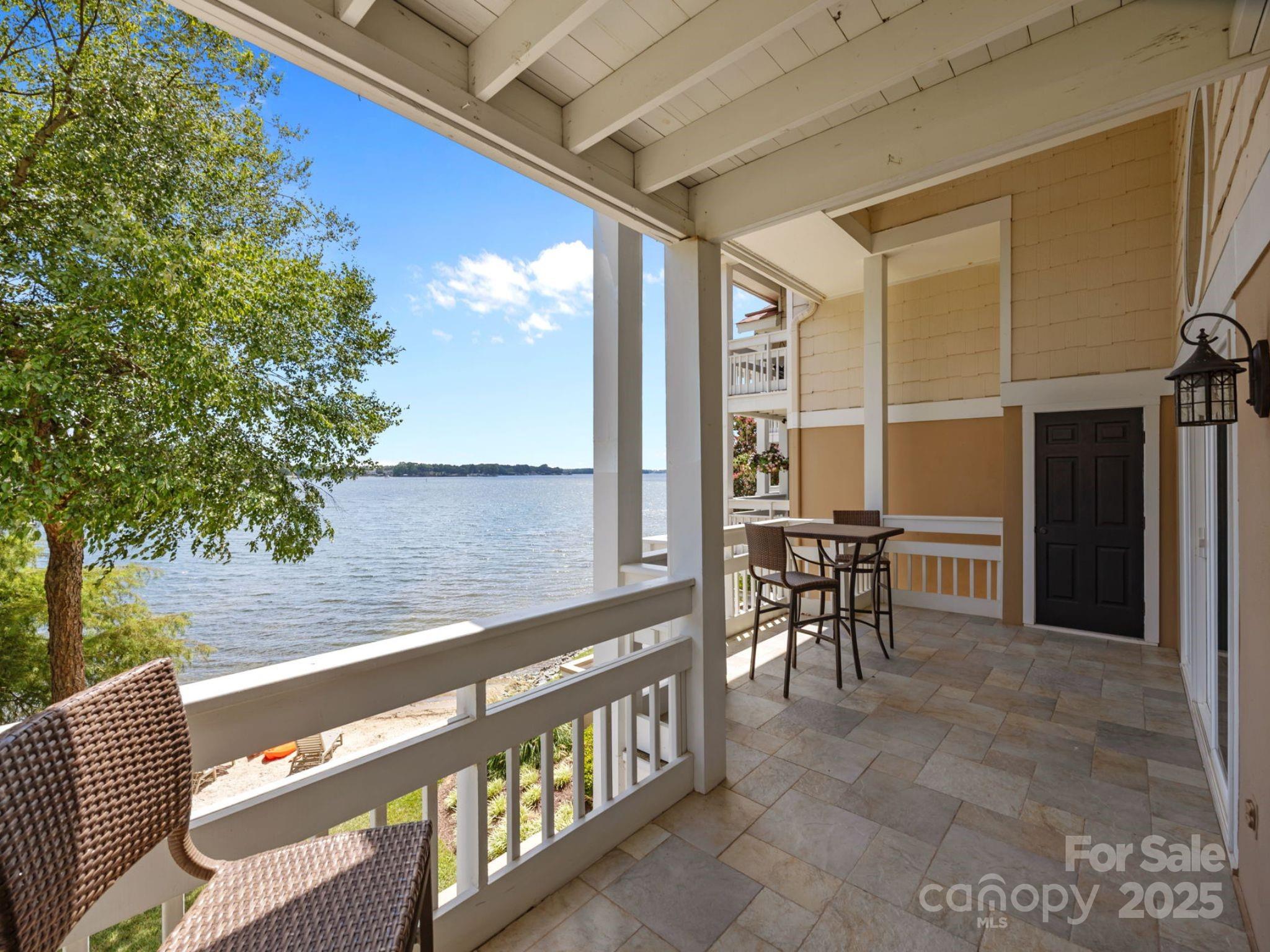 17925 Kings Point Drive, Unit F Cornelius, NC 28031 - Photo 26 of 35 a view of a chairs and table in the balcony