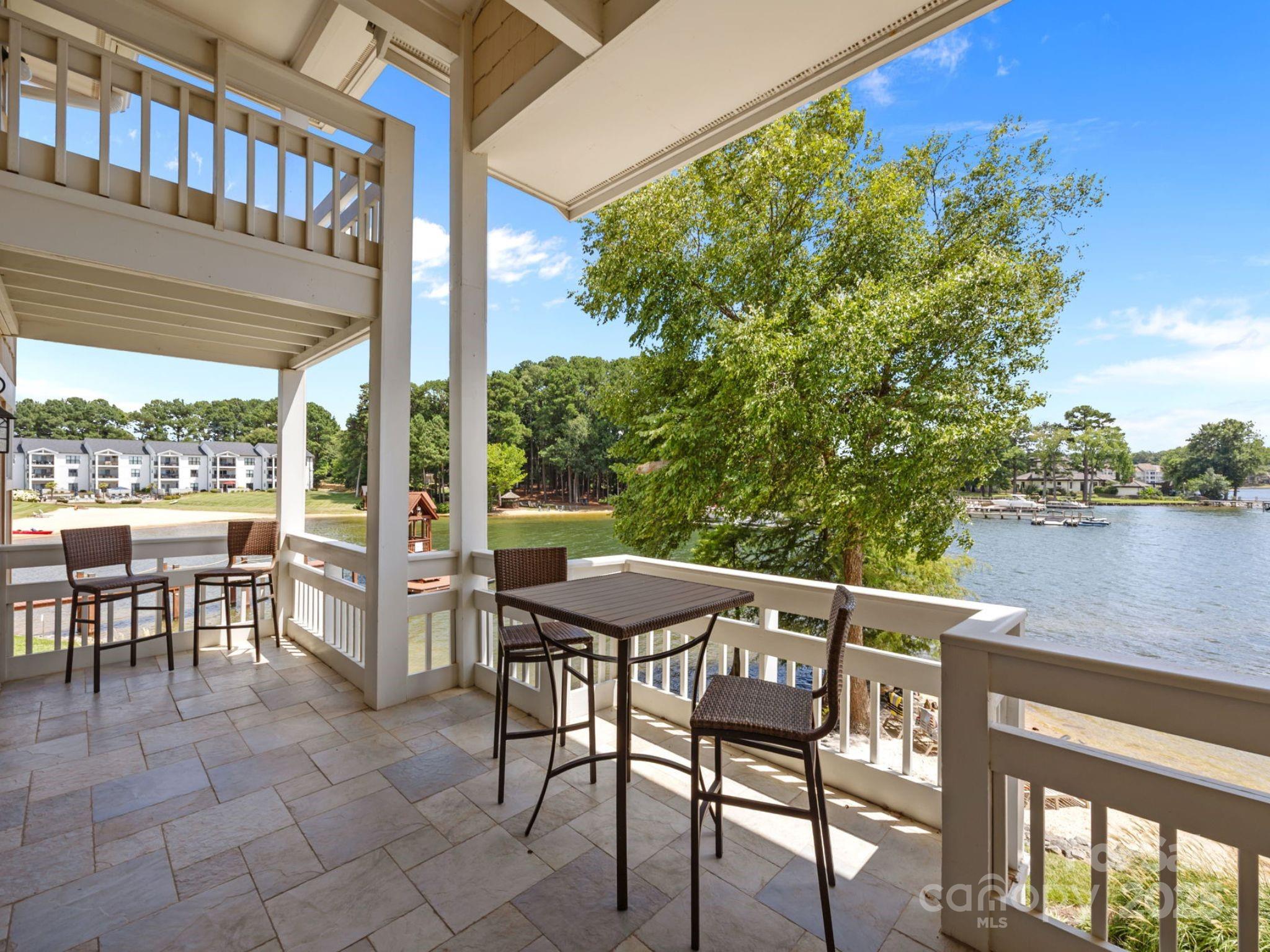 17925 Kings Point Drive, Unit F Cornelius, NC 28031 - Photo 27 of 35 a patio with table and chairs and potted plants