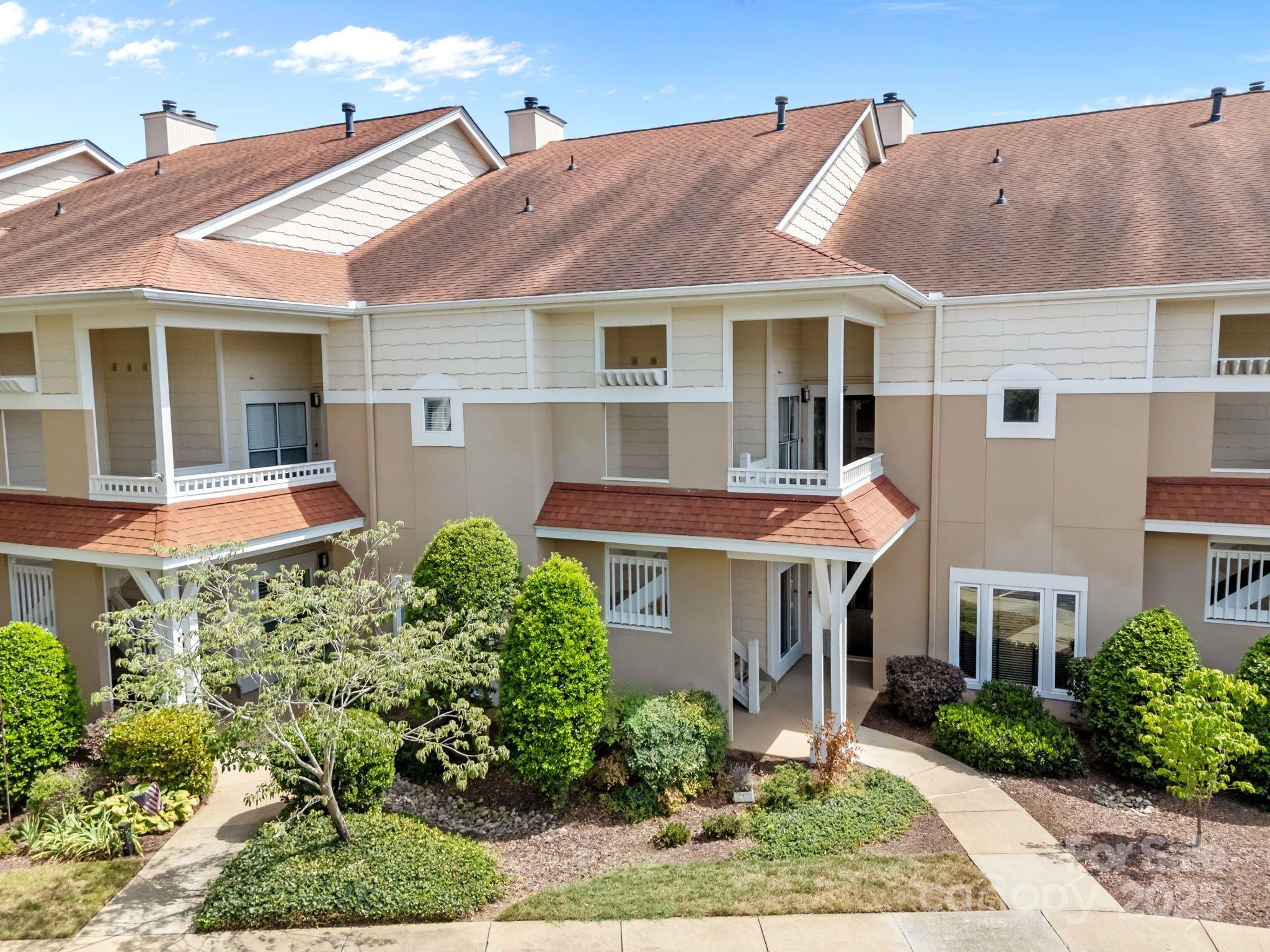 17925 Kings Point Drive, Unit F Cornelius, NC 28031 - Photo 29 of 35 a front view of a house with garden