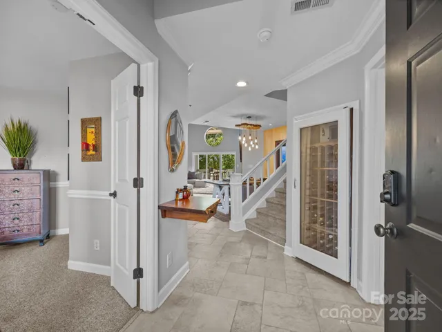 a view of a hallway with livingroom and furniture