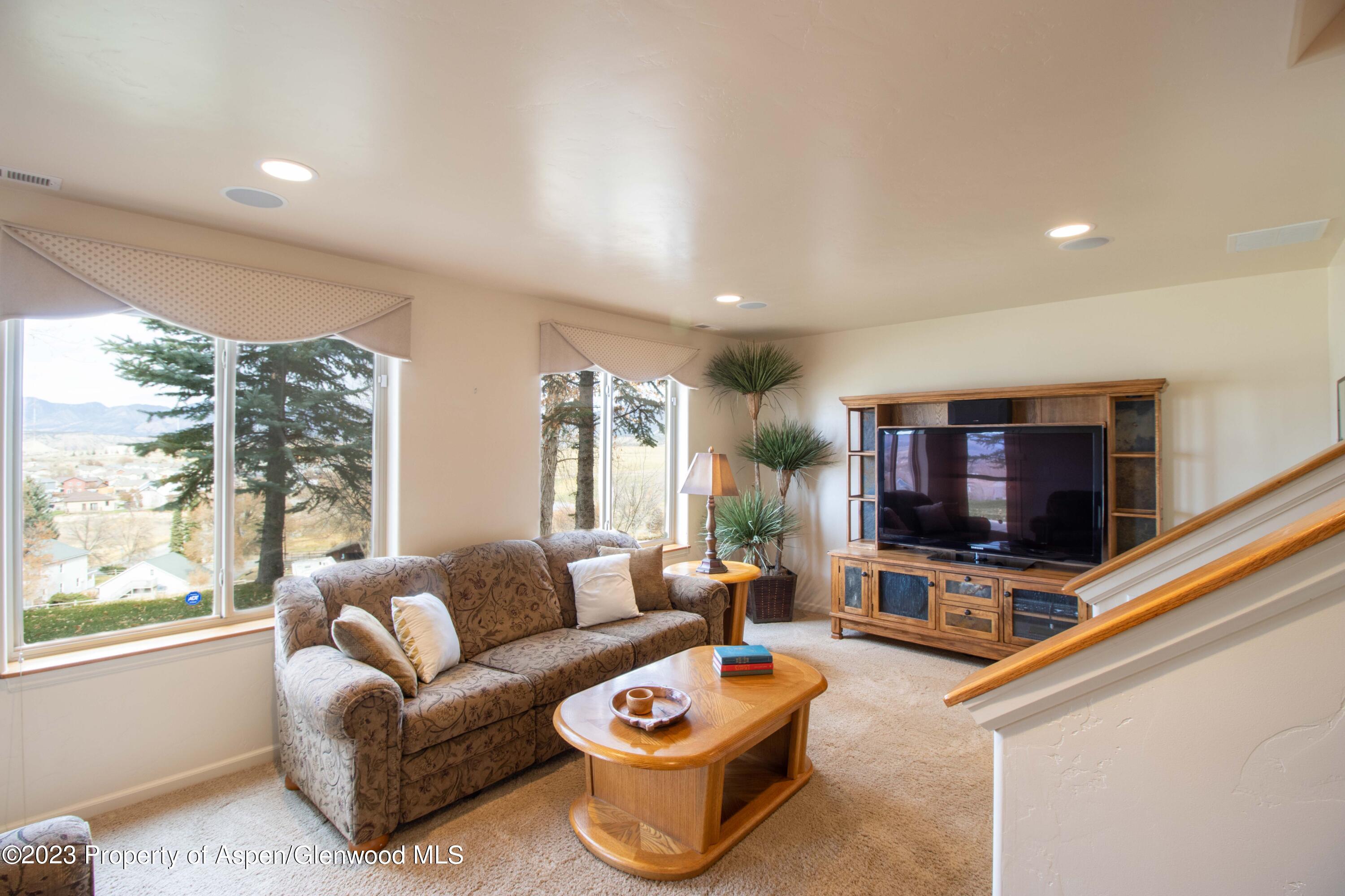 1413 Fir Court Rifle, CO 81650 - Photo 7 of 23 a living room with furniture and a flat screen tv