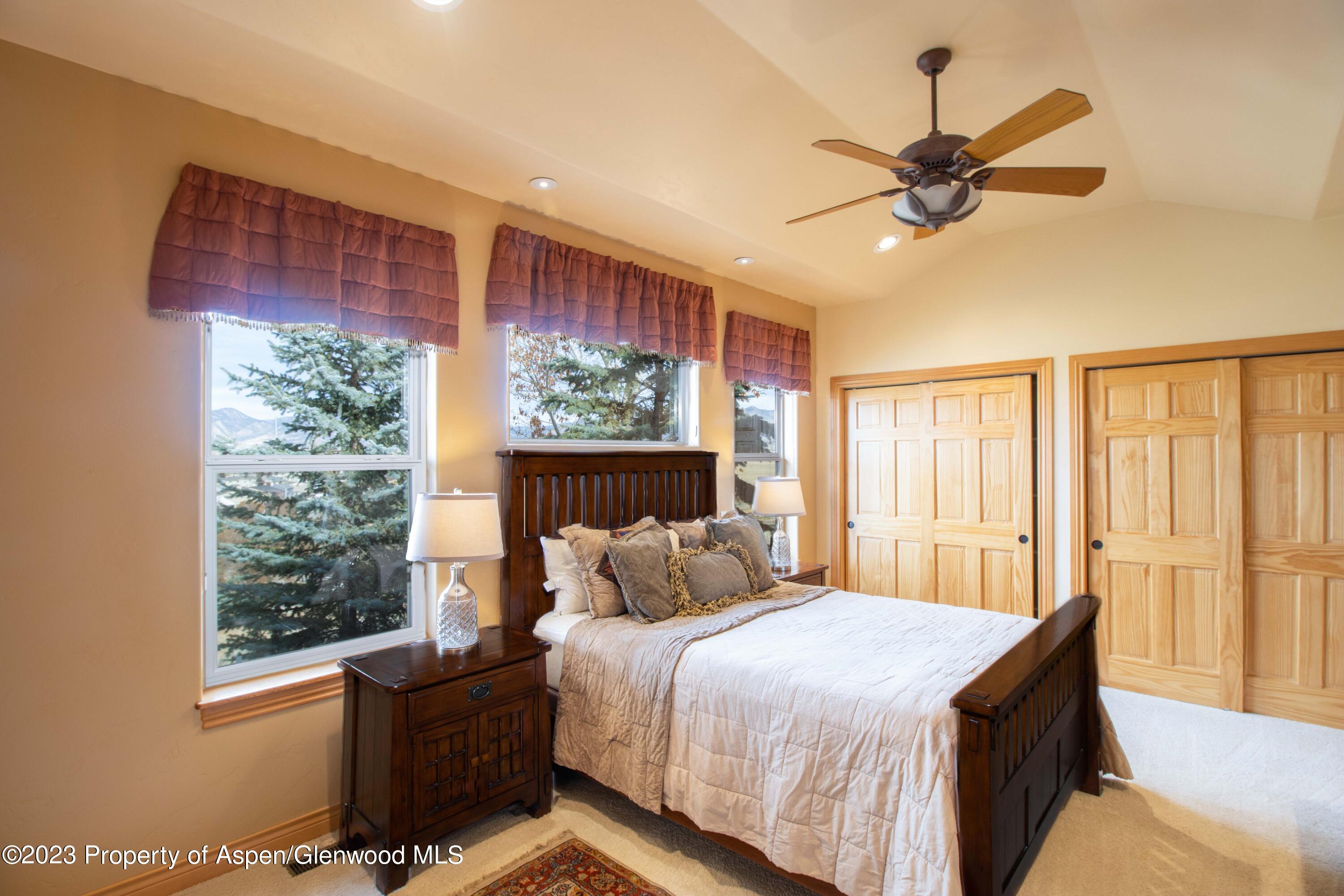 1413 Fir Court Rifle, CO 81650 - Photo 8 of 23 a bedroom with a large bed and a window