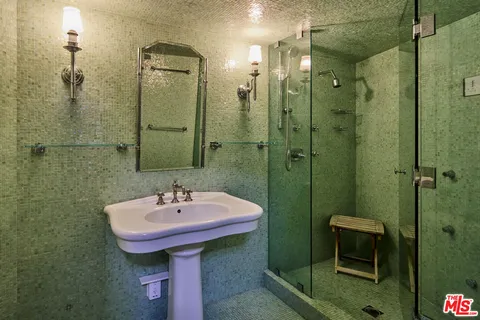 a bathroom with a sink shower and toilet