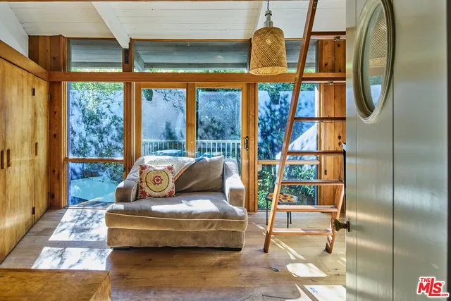 a living room with furniture and a floor to ceiling window