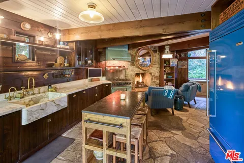 a kitchen with stainless steel appliances granite countertop a sink stove and cabinets