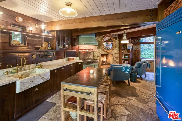 a kitchen with stainless steel appliances granite countertop a sink stove and cabinets
